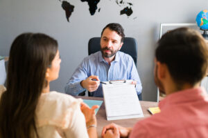 You need to pay attention to your visa application. Sales agent showing a travel permit to some clients at the office before they go on a vacation trip abroad